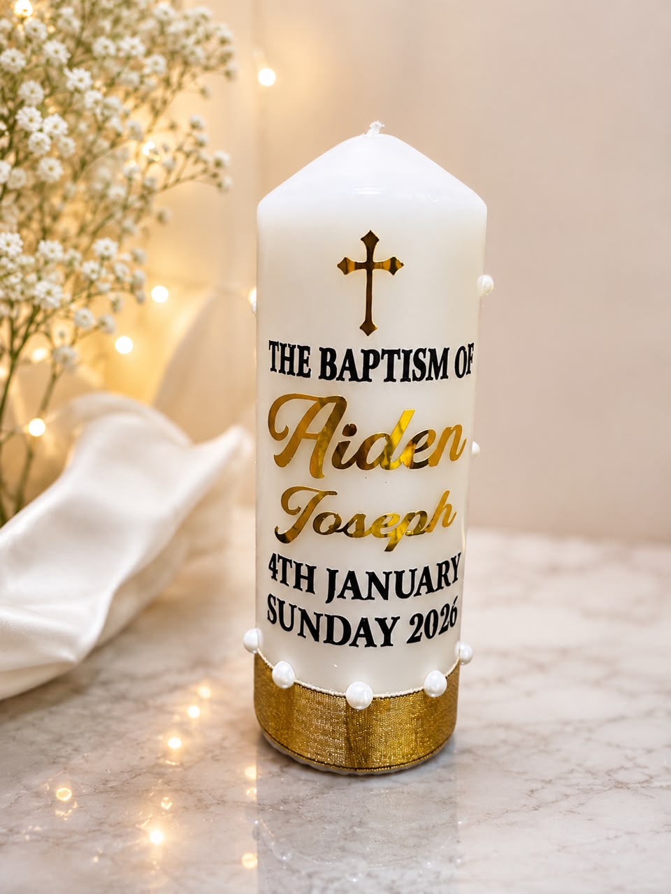 Baptism candle with gold script lettering, pearls and a gold ribbon base