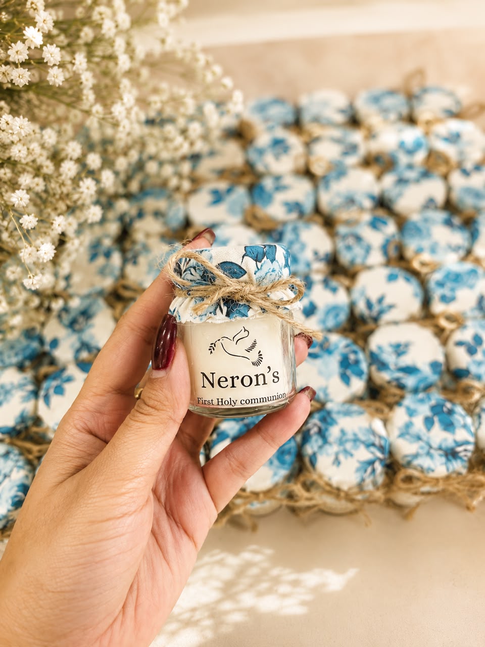 Tray of first holy communion mini jar candle favours tied with jute twine
